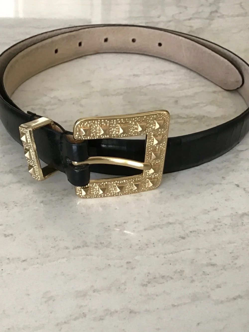 Black leather belt with gold textured buckle